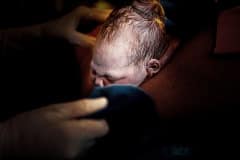 photo-of-baby-emerging-from-mom-by-birth-photographer-leona-darnell